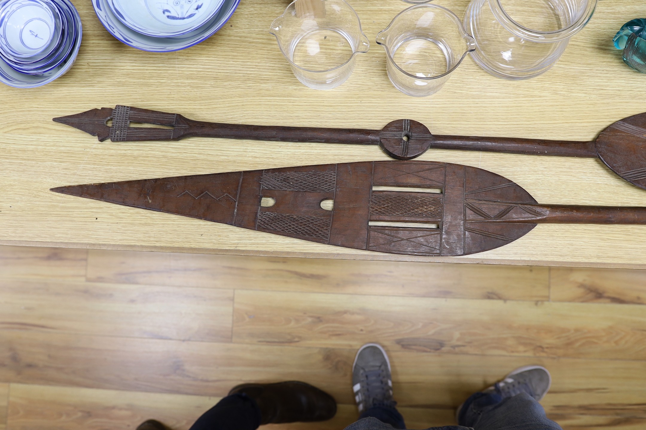 A pair of carved wood paddles, possibly Polynesian. 155cm long